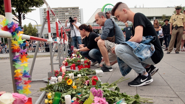 People lay flowers near the scene of a shooting that left 10 dead, including the gunman, in Munich on Friday.