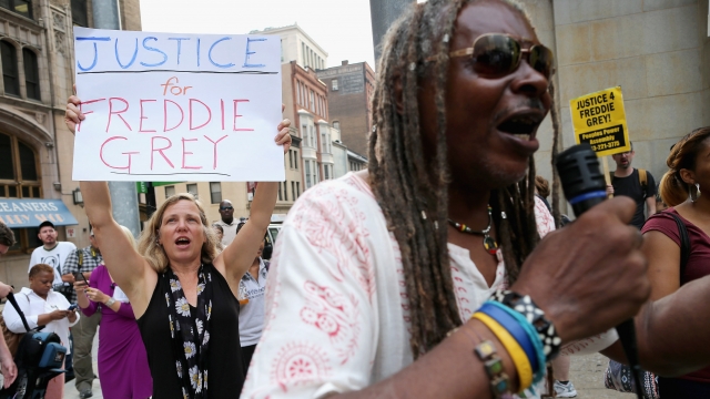 A small and peacful group of demonstrators gather to protest on September 2, 2015 in Baltimore, Maryland.