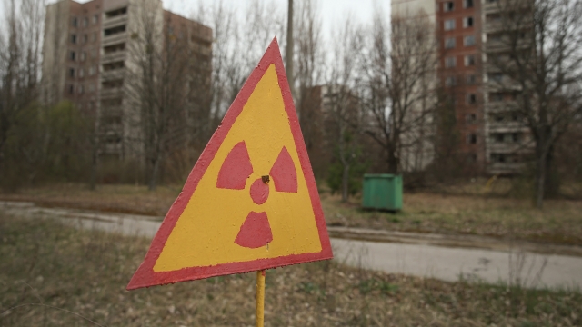A sign warns of radiation contamination near former apartment buildings in Chernobyl.