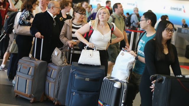 Passengers wait in line to reschedule flights at O'Hare International Airport on September 26, 2014, in Chicago, Illinois.