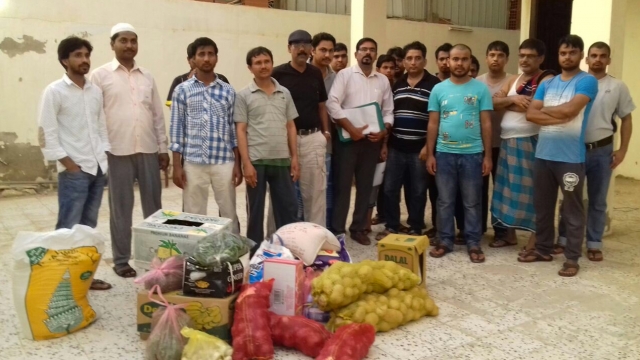 Indian migrant workers get food delivered to them in Saudi Arabia.