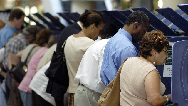 Hispanic voters go to the polls for early voting at the Miami-Dade Government Center on October 21, 2004 in Miami, Florida.