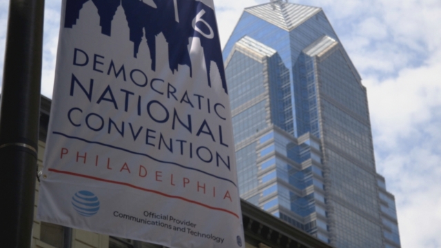 A Democratic National Convention sign hangs from a pole in Philadelphia with Liberty Place in the background
