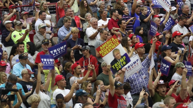 A crowd holds posters at a Trump event on August 1, 2016.