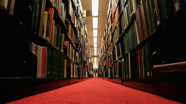 A man browses through books at a library on the Stanford University Campus.