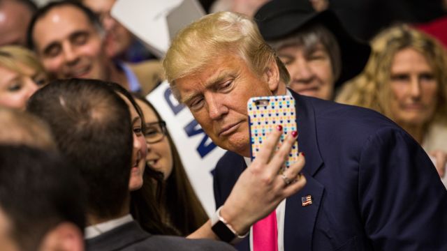 Donald Trump takes a selfie with an attendee at a rally at Green Bay Community College in February 2016