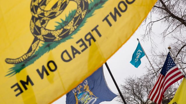 The Gadsden flag is flown during a rally to protest government corruption in Flint, Michigan.