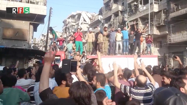 Syrians cheer and celebrate in Aleppo.
