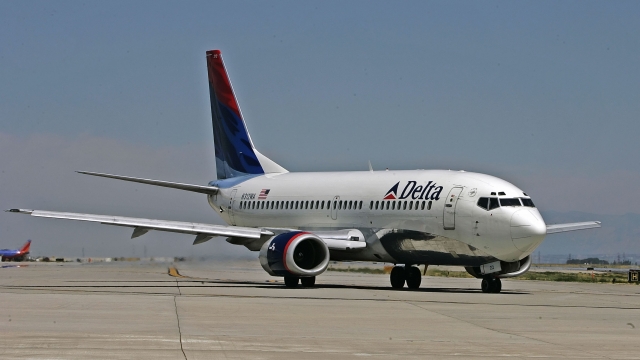 A Delta Air Lines jet taxis for takeoff at Salt Lake International Airport.