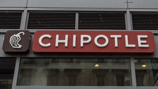 A Chipotle sign is seen on the outside of a restaurant.