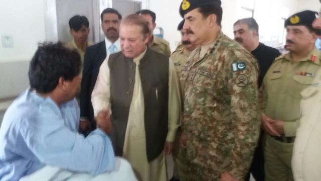 Pakistan's Prime Minister Nawaz Sharif visits a victim of an explosion at a hospital.