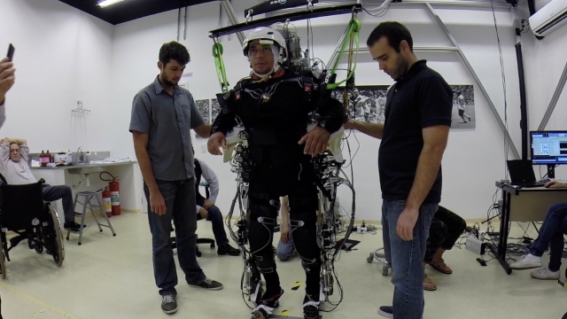 A patient walks using a brain-controlled exoskeleton.