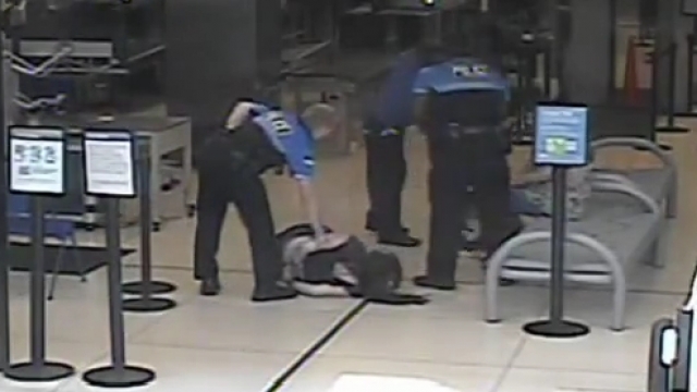 A still image from security camera footage of Hannah Cohen after TSA agents tackled her to the ground.