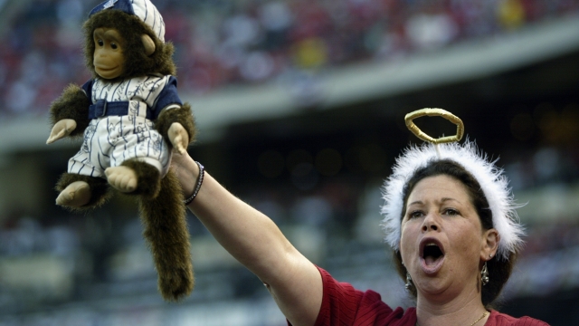 An Angels fan holds up a stuffed Rally Monkey during the Angels' 2002 postseason run.