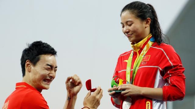 Chinese diver Qin Kai proposes to girlfriend and fellow Olympian He Zi after her medal ceremony.
