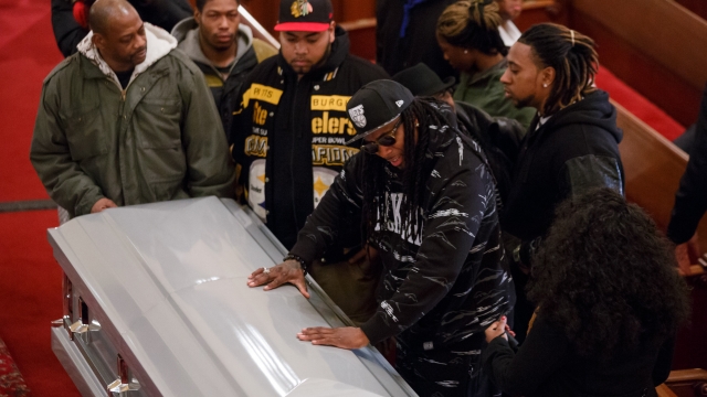 Friends of Akai Gurley touch his casket at the Brown Memorial Baptist Church on December 5, 2014.