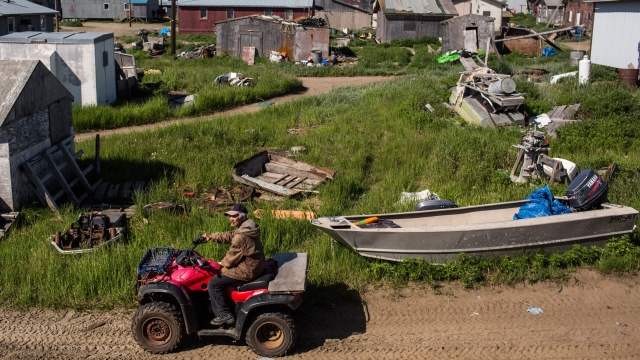 A man drives down the street on an ATV on July 9, 2015, in Shishmaref, Alaska.