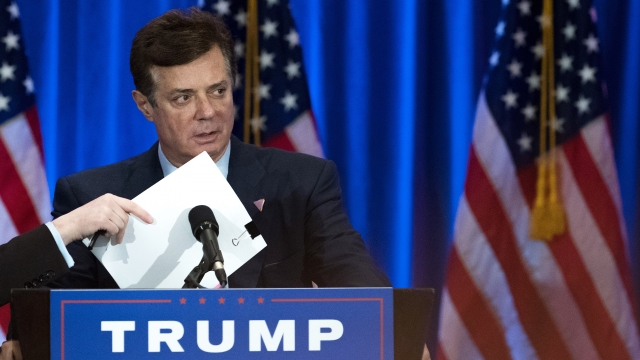 Paul Manafort checks the podium before Republican presidential candidate Donald Trump speaks during an event.