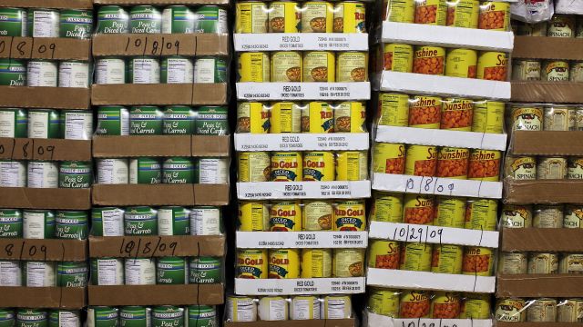 Pallets of canned goods are stacked.