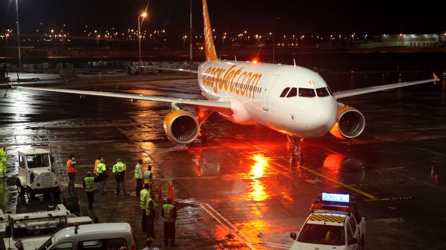 An EasyJet plane is on the tarmac at an airport.