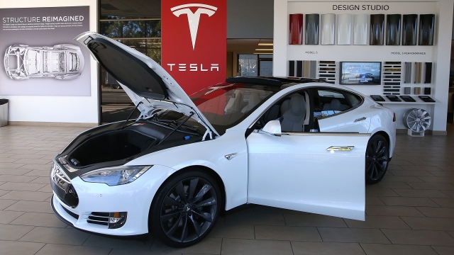 A Tesla Model S car is displayed in a Tesla showroom.