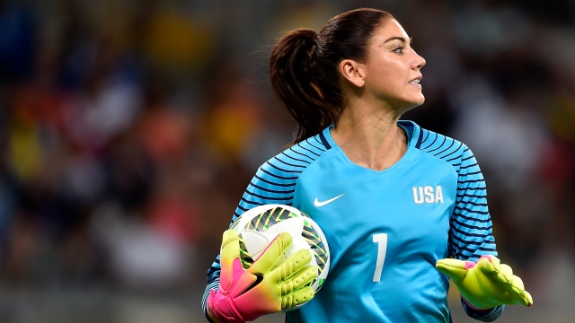 Goalkeeper Hope Solo holds the ball during an Olympic match.
