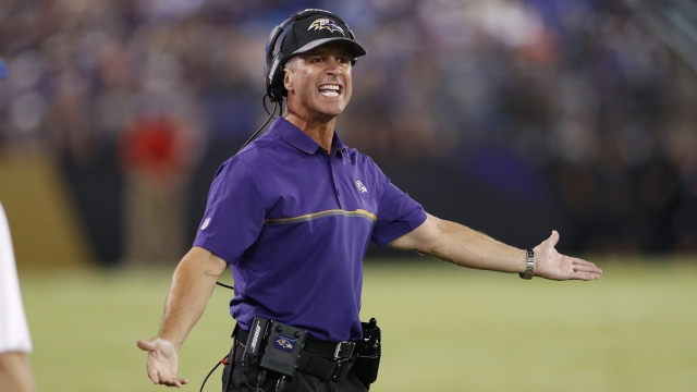 Ravens coach John Harbaugh gestures on the sideline during a preseason game.