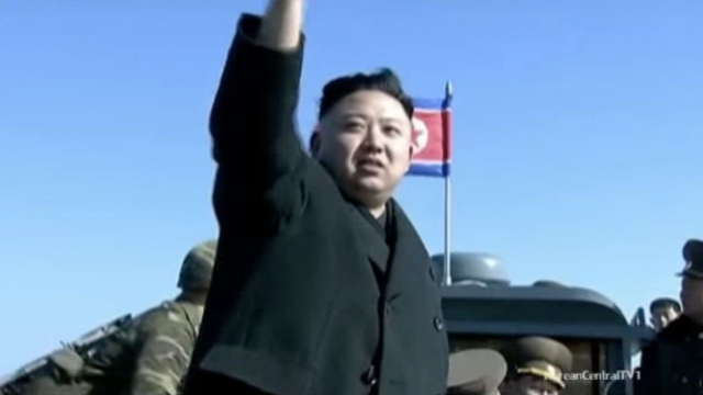 Kim Jong-un waves to soldiers.