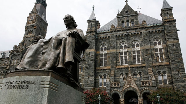 A statue of John Carroll, founder of Georgetown University, sits before Healy Hall on the school's campus on August 15, 2006.