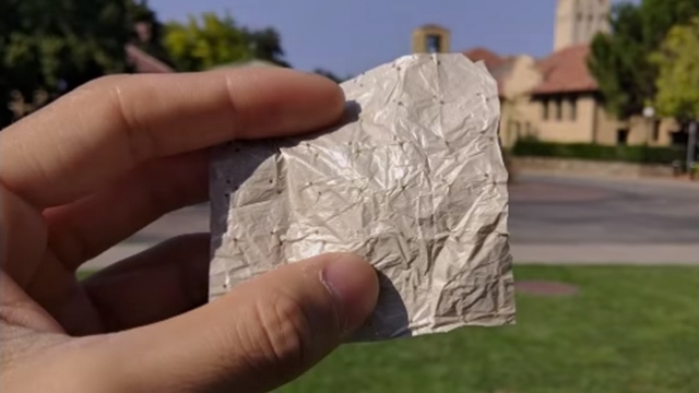 Fingers hold Stanford University's cooling fabric