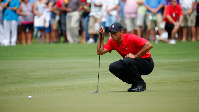 Tiger Woods lines up his birdie putt on the fourth green during the final round of the Wyndham Championship in August 2015.