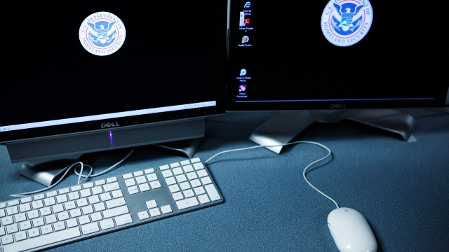 Computers displaying the logo of the Department of Homeland Security