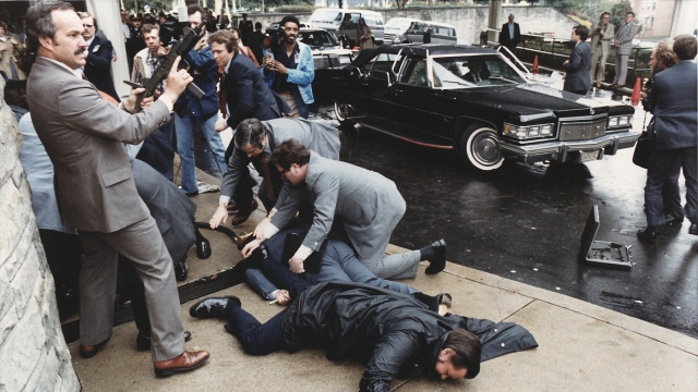 Men lie on the ground as others scramble to help after the shooting of President Ronald Reagan and other officials in 1981.