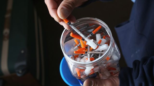 A jar of needles used for heroin injection