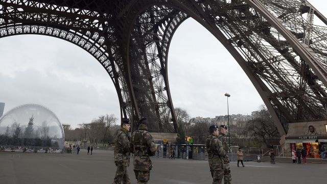 Military personnel patrol the Eiffel Tower on January 8, 2015, in Paris.