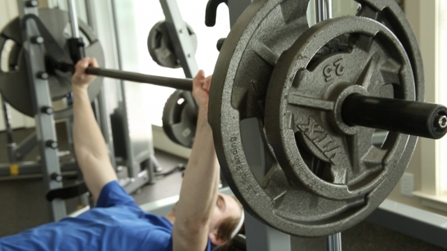 A person lifting weights while exercising