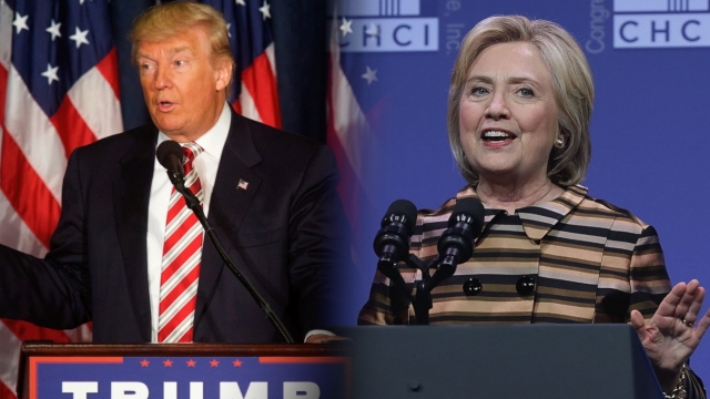 Donald Trump on the left wears a black suit and red, gray and white tie. Hillary Clinton wears a beige, brown and black suit.
