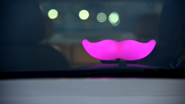 A Lyft Glowstache in a car.