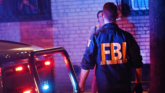 Members of the FBI search an area for evidence at the scene of an explosion in New York City.