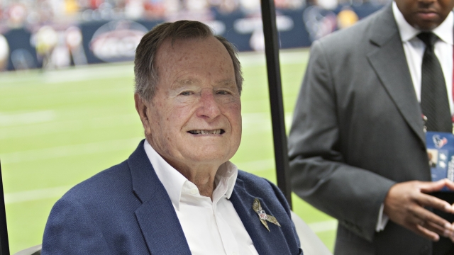Former President George H.W. Bush sits in a golf cart at Salute To Service Day in 2012.