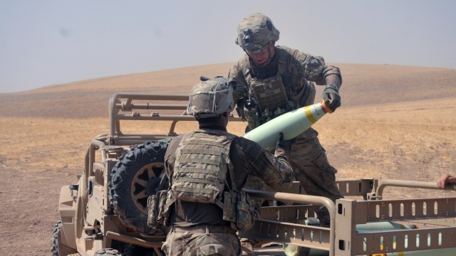U.S. soldiers handle an artillery round in Iraq.