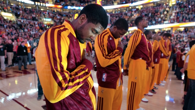 Kyrie Irving No. 2 of the Cleveland Cavaliers bows his head during the national anthem