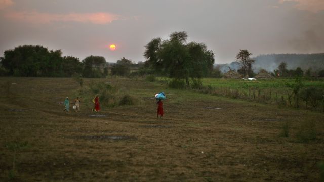 Women carry bundles in a village in India