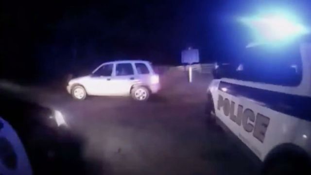 Video shows the deadly shooting of Jeremy Mardis. Two police vehicles face a white SUV and illuminate it in the darkness.