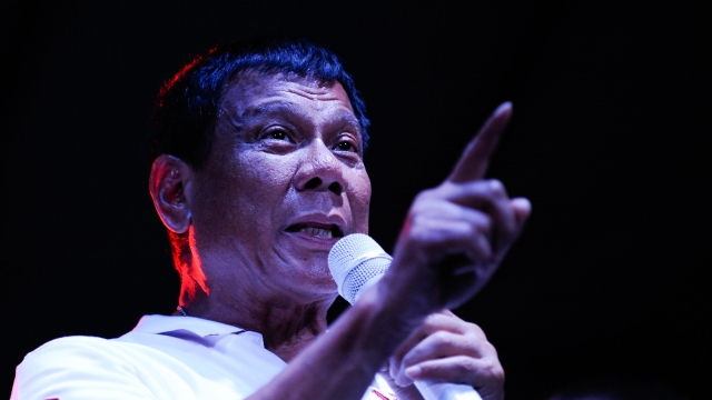 Philippine presidential candidate Rodrigo Duterte gestures during a labor day campaign rally.