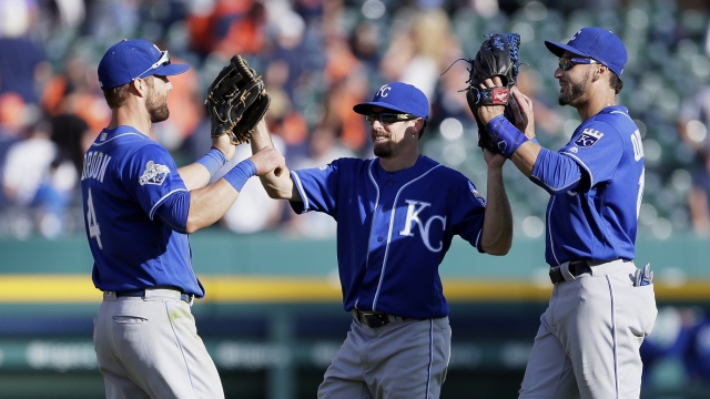 Three Kansas City Royals players celebrate after a win.