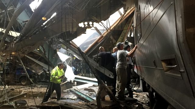 Train personnel survey the N.J. Transit train that crashed into the platform at the Hoboken Terminal September 29, 2016.