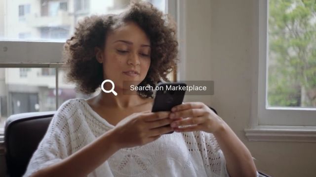 A woman uses Facebook's new Marketplace feature on her smartphone.