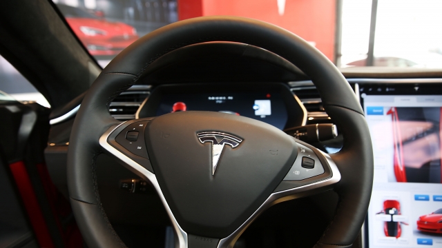 The inside of a Tesla vehicle is viewed as it sits parked in a new Tesla showroom and service center.
