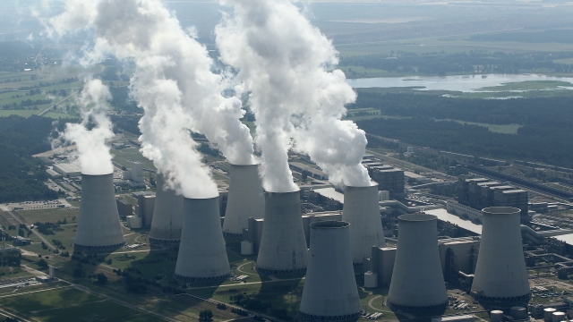 Steam rises from cooling towers at Germany's Jaenschwalde coal-fired power plant.